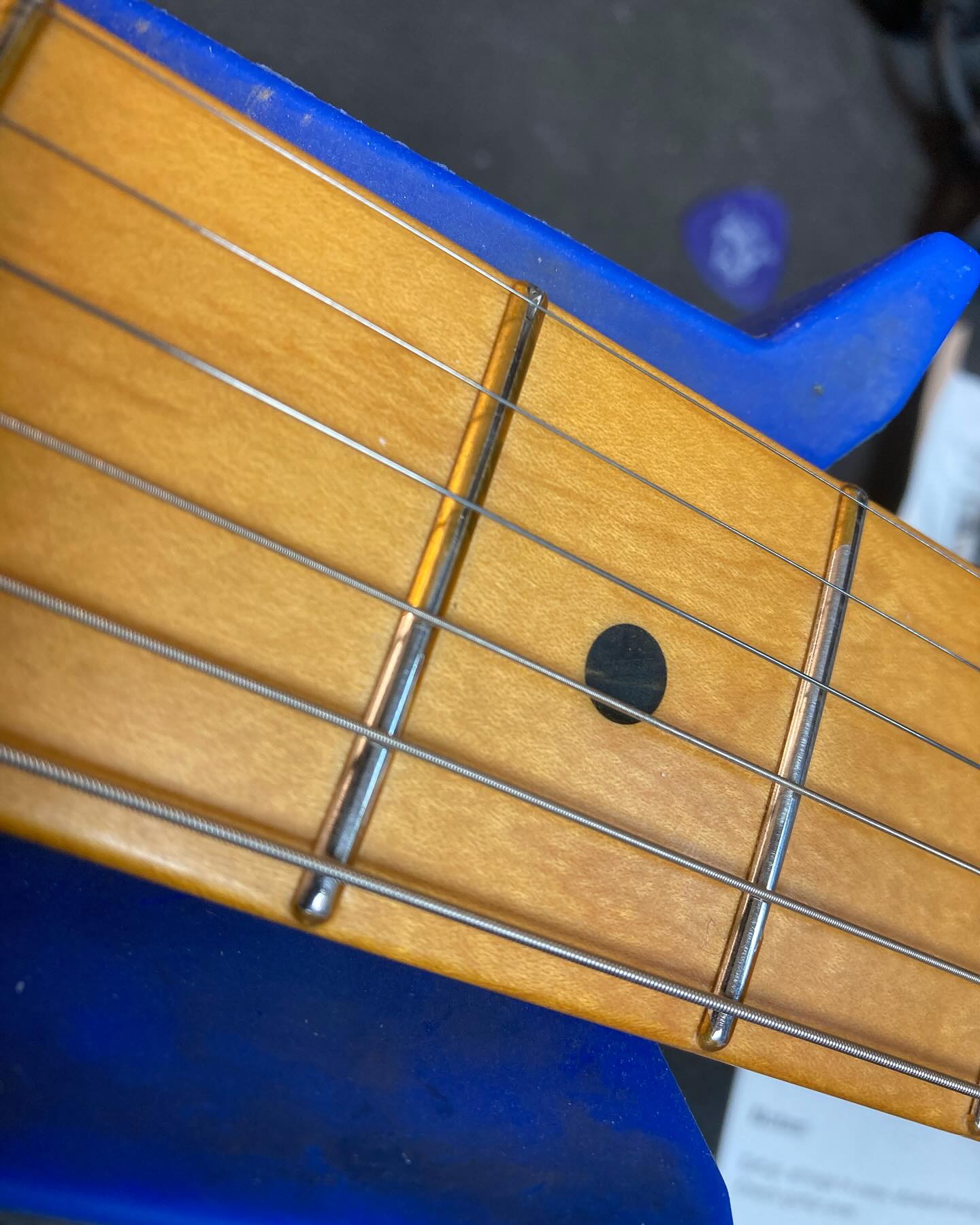 Guitar fretboard showing polyurethan  on frets Guitar fretboard showing polyurethan  on frets