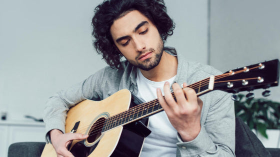 Man practicing guitar Man practicing guitar