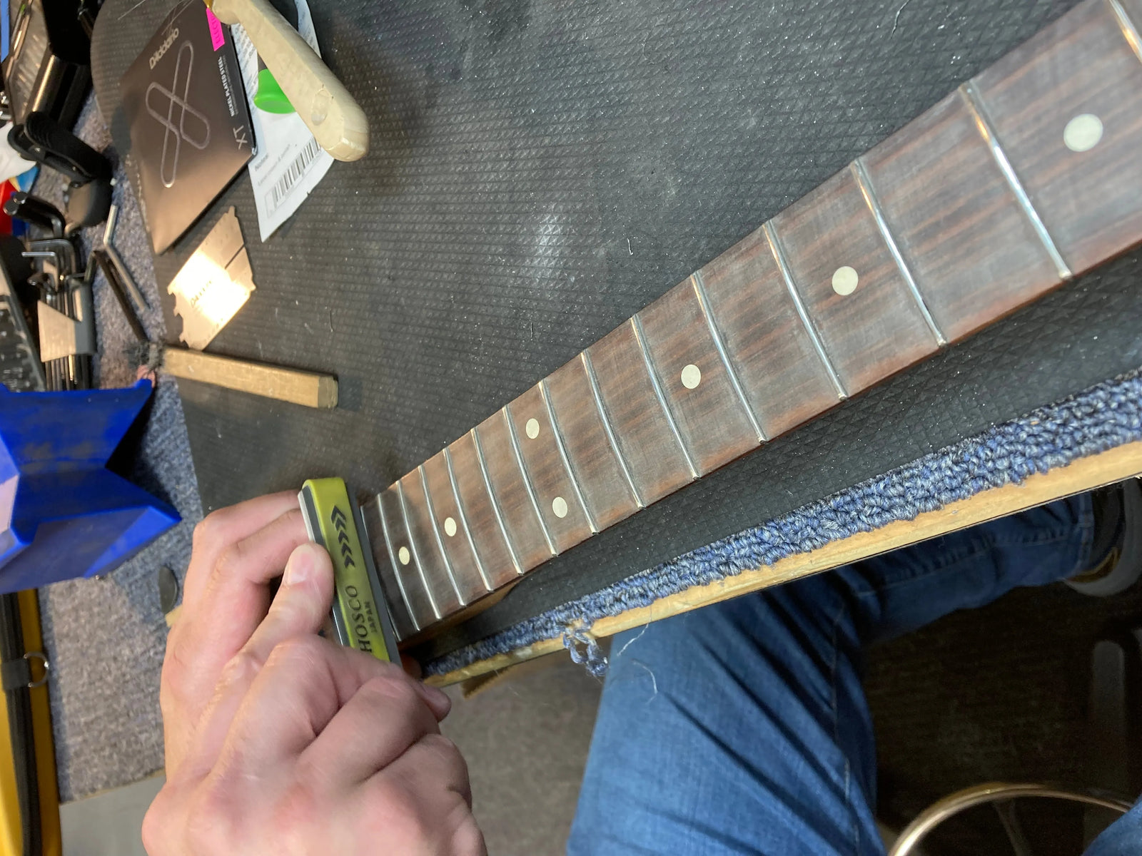 Fretwork being done to guitar neck Fretwork being done to guitar neck