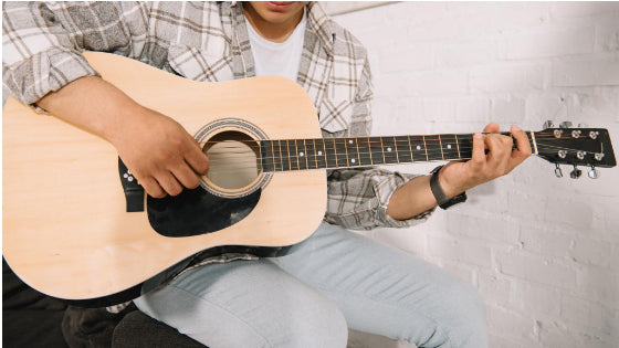 Man playing a guitar Man playing a guitar