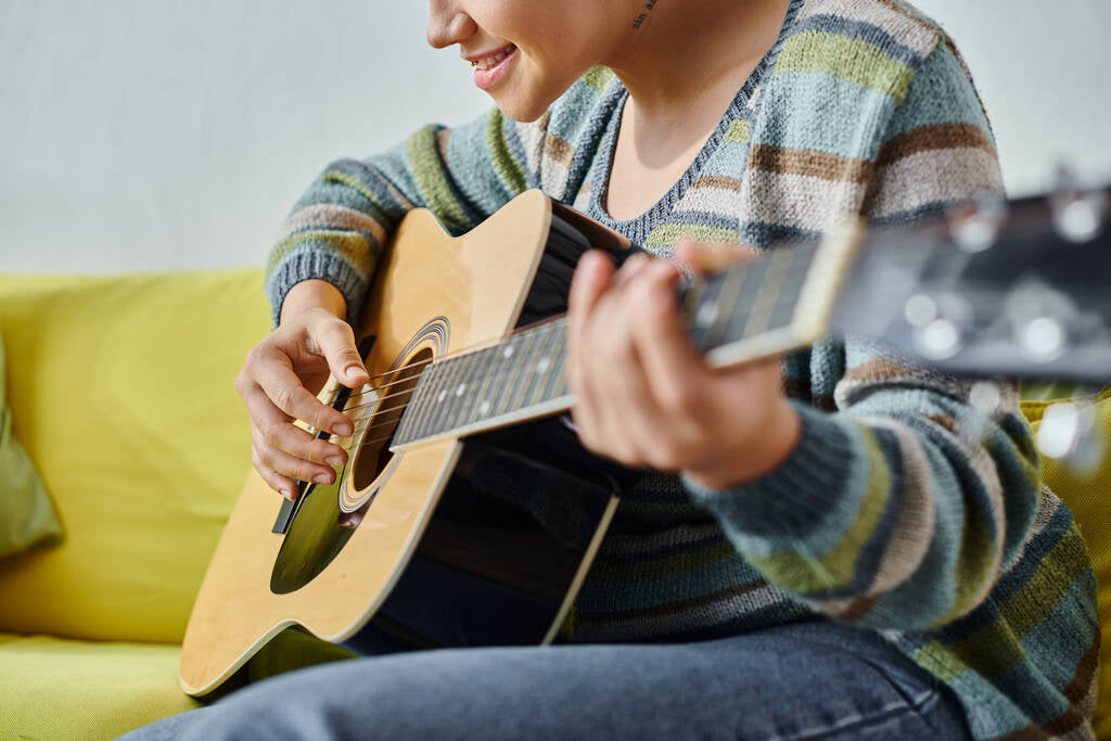 Woman playing an acoustic guitar Woman playing an acoustic guitar