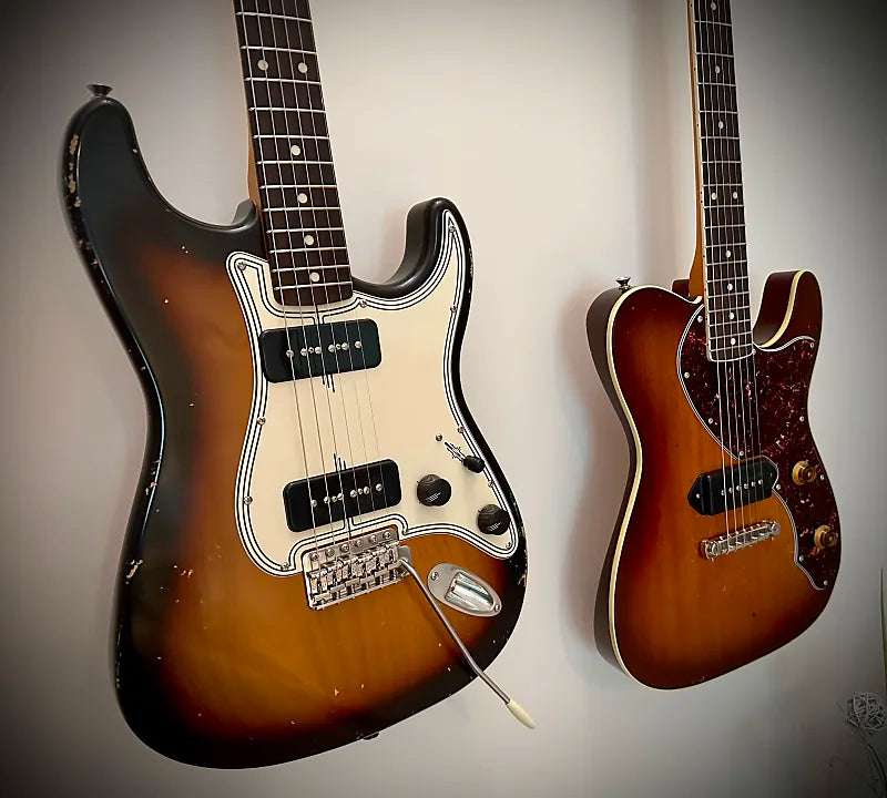 2 Tophat guitars hanging on wall 2 Tophat guitars hanging on wall