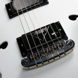 Close-up of the Godin Rik Emmett Premiere Electric Guitar—a limited edition model by Godin—featuring six strings, a black logo-embossed pickup, and a chrome bridge.