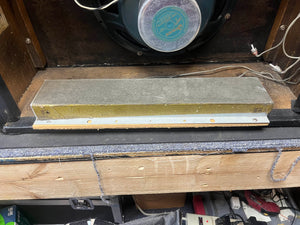 A rectangular metal reverb tank is mounted inside an open wooden cabinet with visible wires beneath the speaker—a classic feature of the 1965 Fender Deluxe Reverb AB763 (Pre-CBS Blackface, Serial A 06439) amplifier by Fender.
