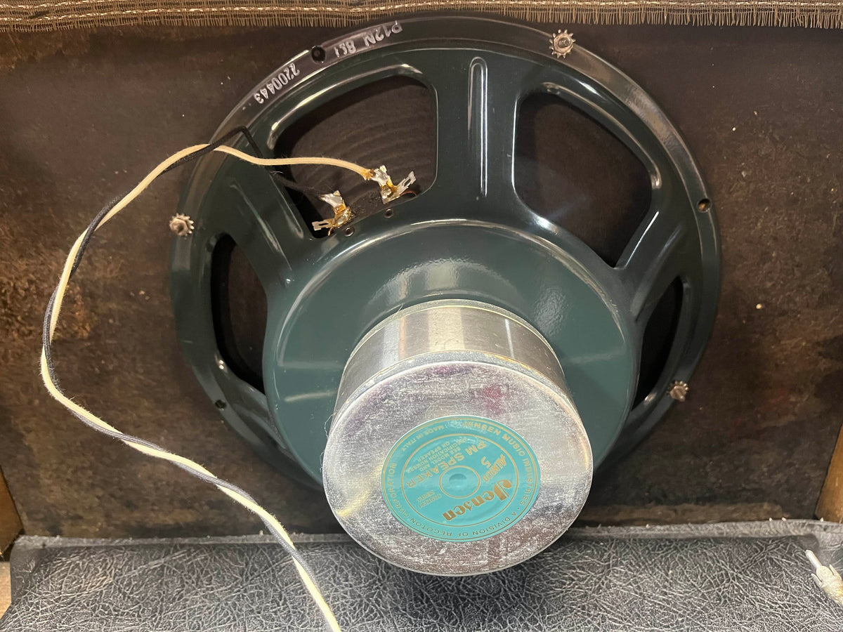 A close-up of a vintage Jensen P15N speaker installed in a 1965 Fender Deluxe Reverb AB763 Pre-CBS Blackface (Serial A 06439) amp cabinet, showing wiring connected to the speaker terminals.