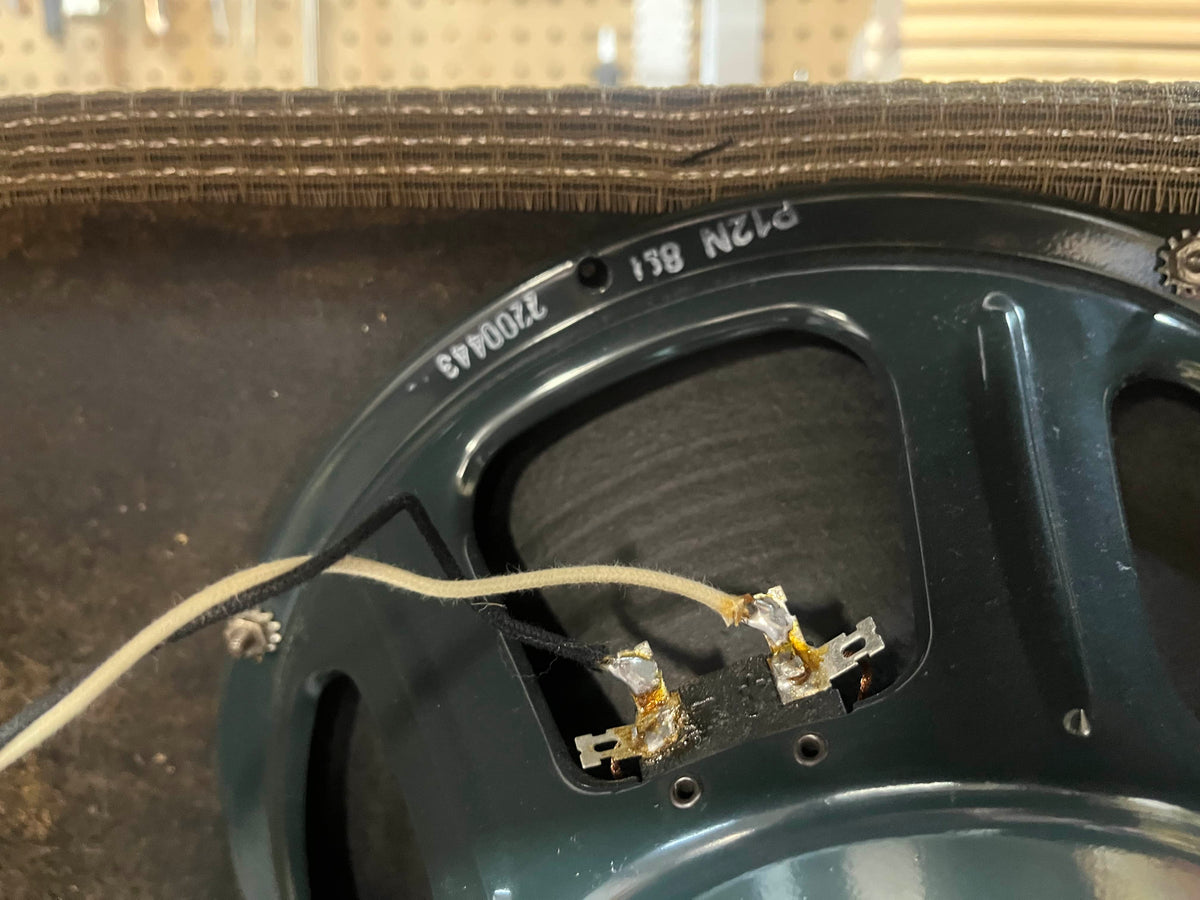 Close-up of the wiring connections and part number 220043 on the back of a speaker from a 1965 Fender Deluxe Reverb AB763 Pre-CBS Blackface Serial A 06439 amplifier.