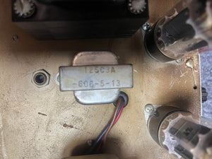 Close-up of an electronic component labeled "125C3A 606-5-13" with wires inside a vintage Fender Deluxe Reverb AB763 (Pre-CBS Blackface, serial A 06439) tube amp from 1965.