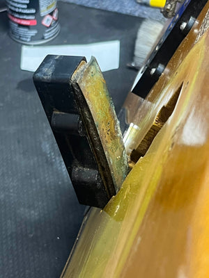 Close-up of a damaged 1966 Fender Jazz Bass Natural Refinish by Fender, showing a partially detached original pickup, visible internal components, and worn wood. Comes with case.