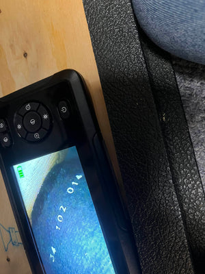 A close-up of a digital camera displays numbers “34 102 014” on a blue surface, referencing a Marshall 1969 4x12 Cabinet with matching Celestion T1281 Greenbacks; part of the camera and its surroundings are visible.
