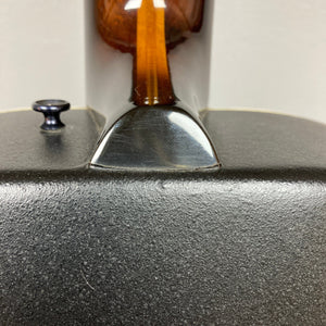 Close-up of a 1976 Ovation 1112-1 Acoustic Guitar neck joint showing wood grain, metal strap button, and hints of its Lyrachord rounded back. USA-made, includes case.