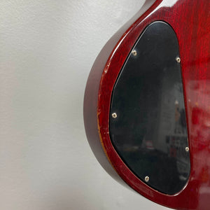Close-up of the back of a Gibson 1977 SG Standard Cherry electric guitar, featuring a mahogany body and a black plastic electronics cover plate secured with screws—a classic detail from the Kalamazoo era.