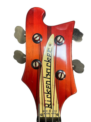 Close-up of a 1978 Rickenbacker 4001 Bass headstock in Fireglo (Serial RL7346) with silver tuners and "Rickenbacker" logo on the truss rod cover, shown on gray carpet—ideal for vintage bass enthusiasts. Includes OHSC.