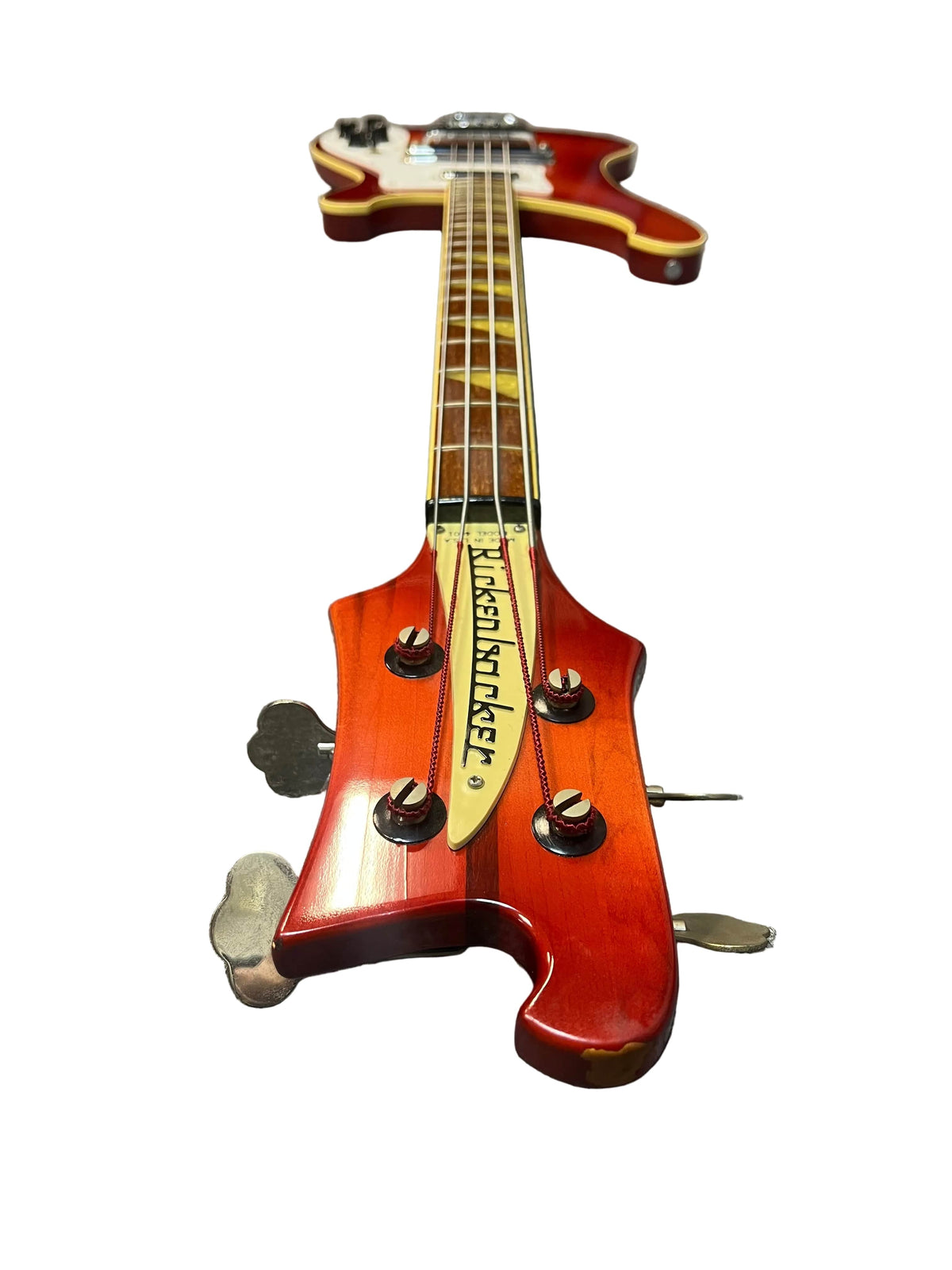 A 1978 Rickenbacker 4001 Bass in Fireglo (Serial RL7346) is shown from the headstock, featuring four tuning pegs and "Rickenbacker" on the truss rod cover, isolated on a white background.