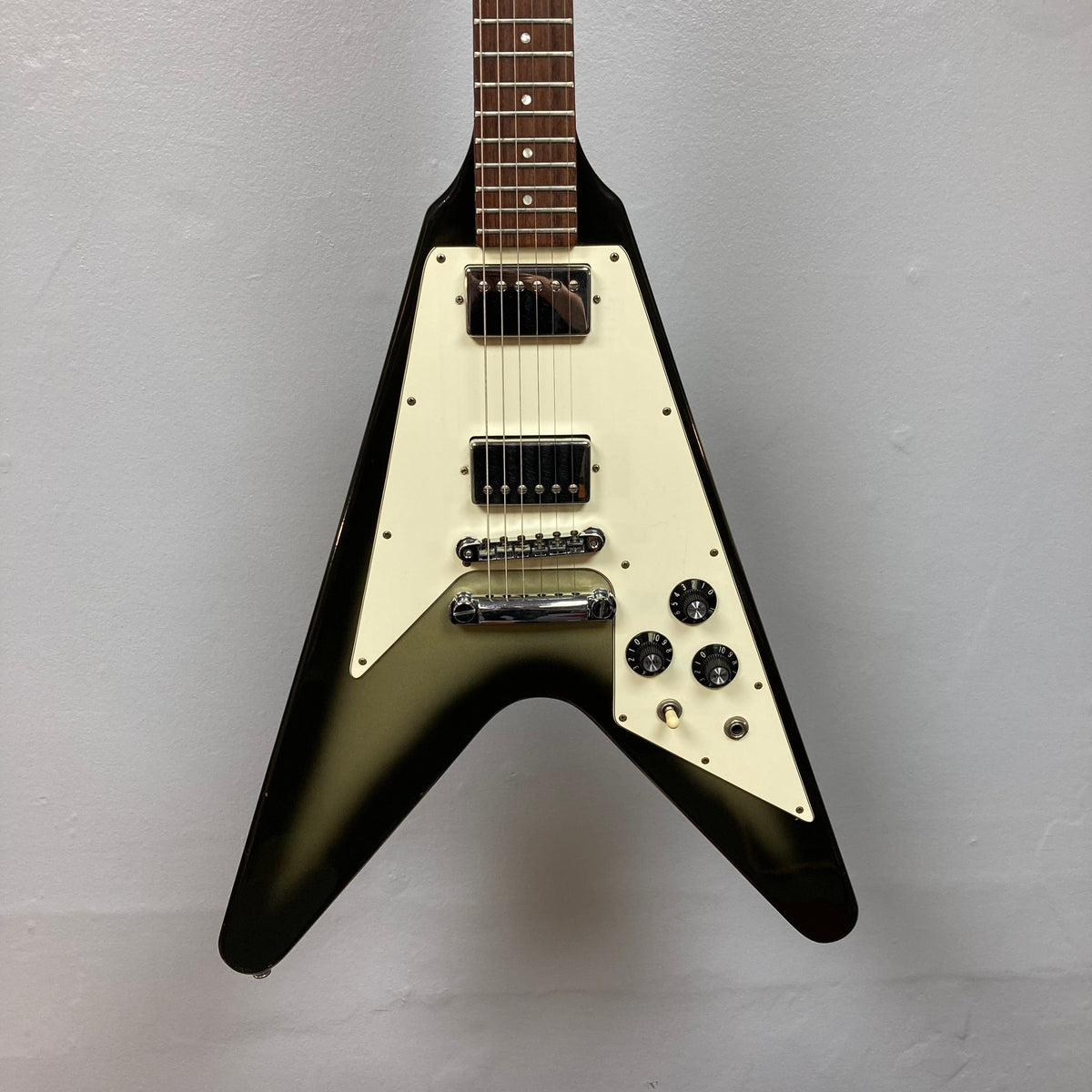 1979 Gibson Flying V Silverburst w/Case, showcasing vintage craftsmanship with minor blemishes, striking shape, and original case. Iconic piece from Guitars on Main's consignment collection.