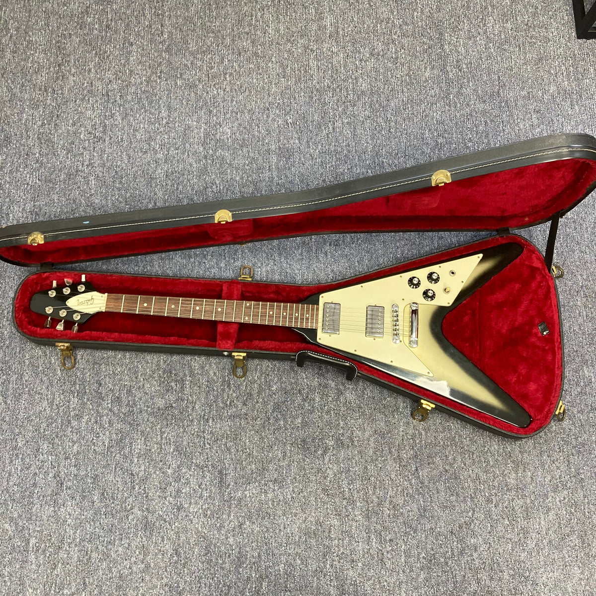 1979 Gibson Flying V Silverburst in original case, showcasing its vintage charm and minor blemishes, available at Guitars on Main.