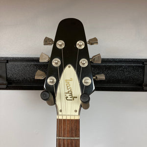 1979 Gibson Flying V Silverburst guitar head close-up, showcasing strings and tuning pegs, highlighting its vintage craftsmanship.