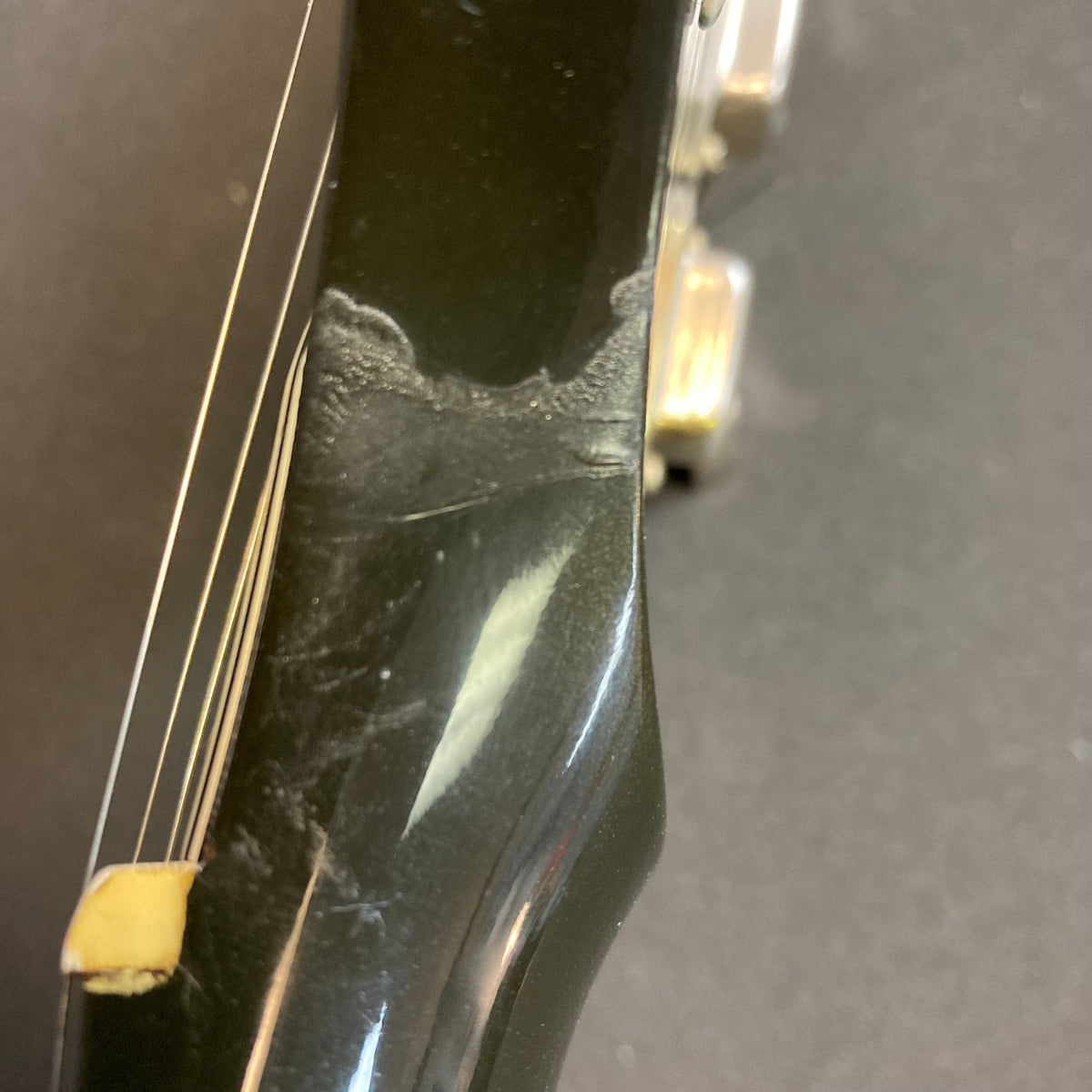 Close-up of a 1979 Gibson Flying V Silverburst guitar with minor blemishes, showcasing its iconic shape and vintage craftsmanship, includes original case.