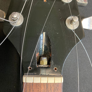 1979 Gibson Flying V Silverburst guitar close-up, showcasing minor blemishes and its unique shape, paired with its original case.
