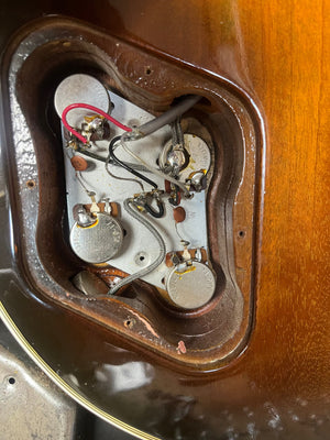 Close-up of the wiring and control cavity inside a 1980 Gibson Les Paul Custom – Tobacco Sunburst w/OHSC by Gibson, highlighting vintage potentiometers, wires, and shielding found in classic Les Paul models.
