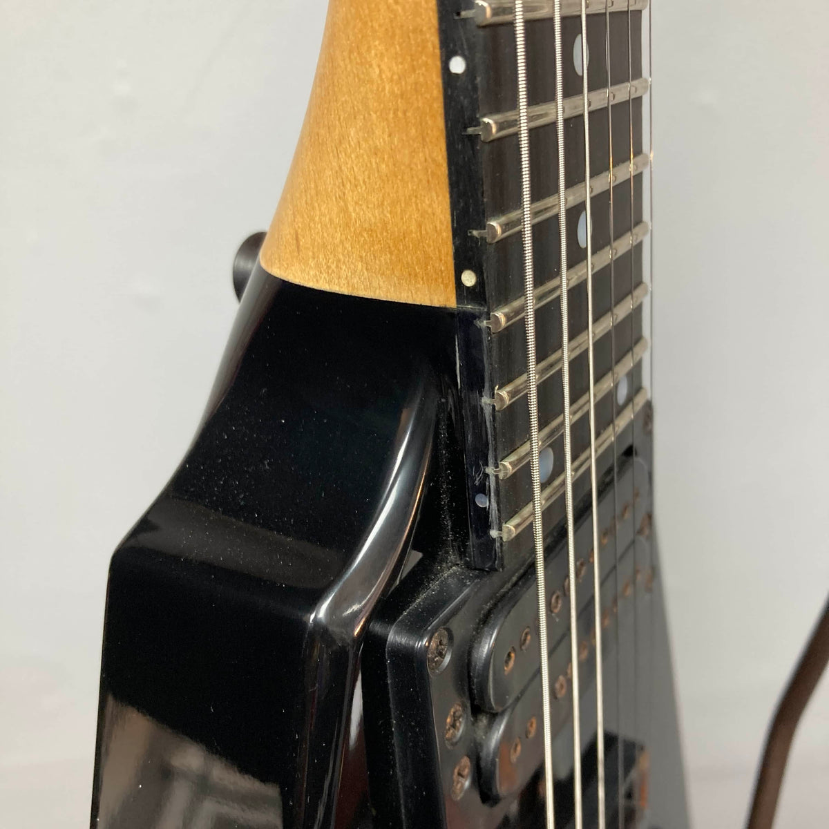 Close-up of a 1992 Carvin Ultra V USA electric guitar, featuring the neck joint, strings, and part of the fretboard. Shown with a Kahler Steeler Trem and MJ‑wound Seymour Duncan DCJ pickups against a plain background.