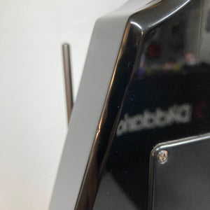Close-up of a glossy black Carvin 1992 Ultra V USA, with a metal antenna and blurred reflection—echoing the precision of its Kahler Steeler Trem and MJ‑wound Seymour Duncan DCJ pickups.