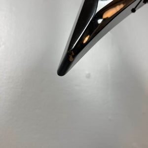 Close-up of the tip of a 1992 Carvin Ultra V USA – Kahler Steeler Trem, MJ-Wound Seymour Duncan DCJ guitar with a small chipped area showing a lighter color underneath, set against a plain white background.