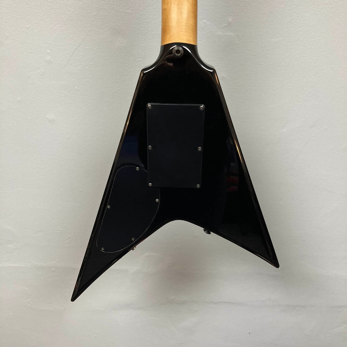 Back view of a 1992 Carvin Ultra V USA guitar body with Kahler Steeler Trem and MJ‑Wound Seymour Duncan DCJ, showing two access panels, against a plain white wall.