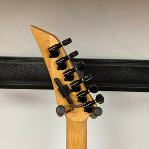 The image shows the back of a 1992 Carvin Ultra V USA electric guitar headstock, featuring six black tuners and a locking nut on a light wood neck. This model includes a Kahler Steeler Trem and MJ-wound Seymour Duncan DCJ pickups.