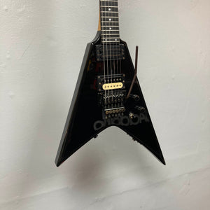A 1992 Carvin Ultra V USA electric guitar in black, featuring a V-shaped body, MJ-wound Seymour Duncan DCJ pickups, and a Kahler Steeler tremolo, photographed against a plain light-colored wall.