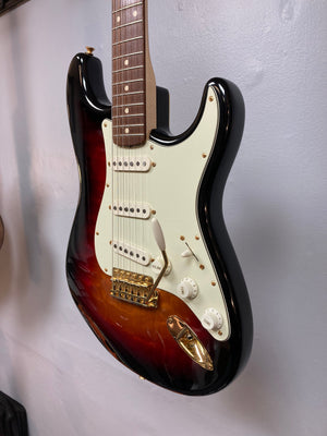 Fender Custom Shop 1960s FMT Stratocaster 1998 displayed on a wall, showcasing its meticulous craftsmanship and iconic design elements.