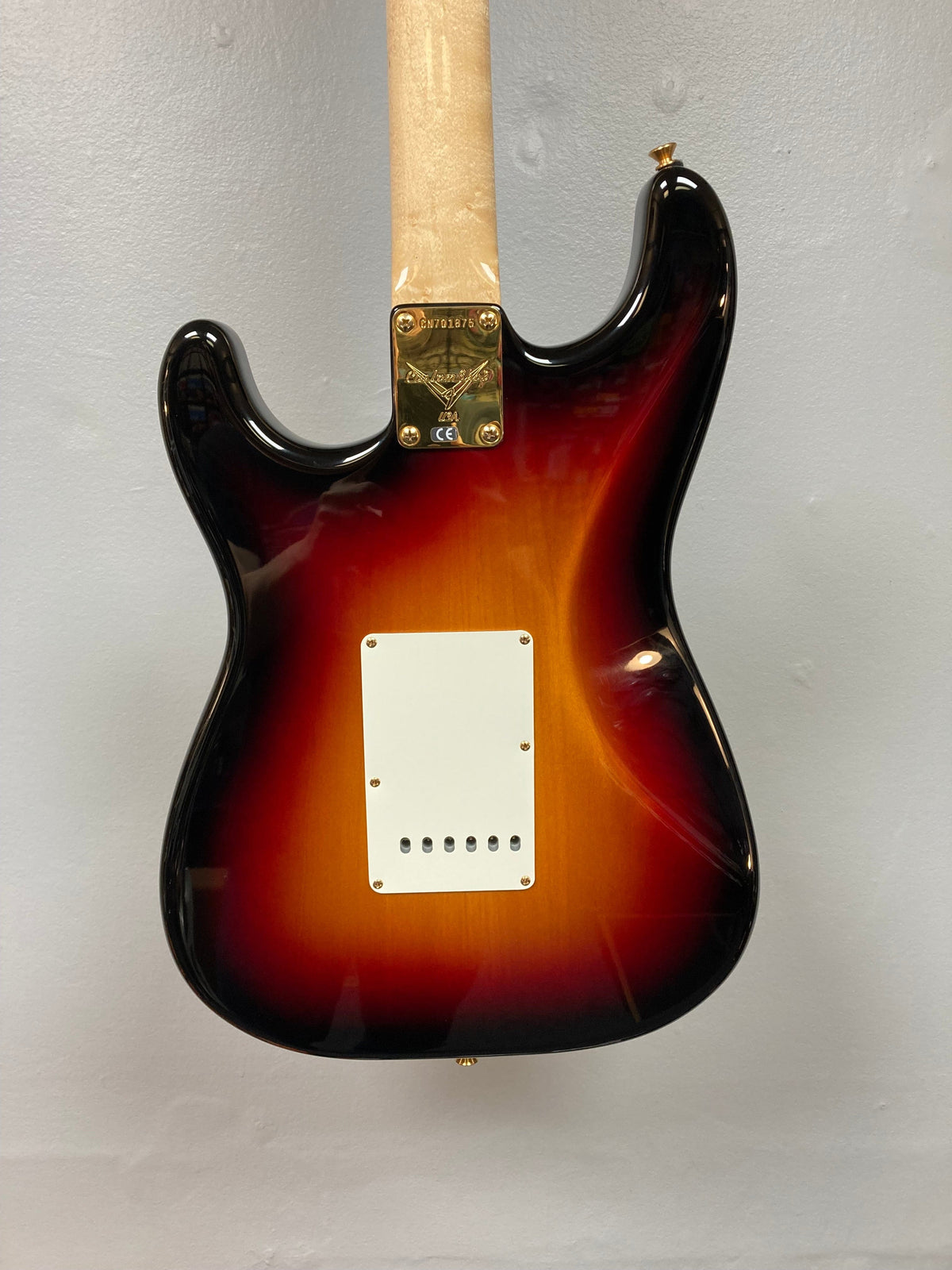 Close-up of 1998 Fender Custom Shop 1960s FMJ Stratocaster guitar neck and body, featuring meticulous craftsmanship and iconic woodwork.