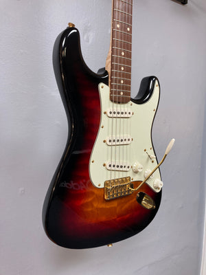 Fender Custom Shop 1960s FMT Stratocaster 1998 displayed on a wall, showcasing its exquisite craftsmanship and vintage appeal.