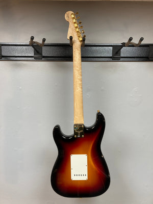 Fender Custom Shop 1960s FMJ Stratocaster 1998 guitar displayed on a wall hook.