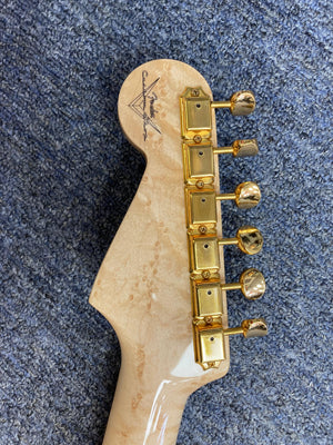 Close-up of a 1998 Fender Custom Shop 1960s FMJ Stratocaster, showcasing meticulous craftsmanship and iconic woodwork.