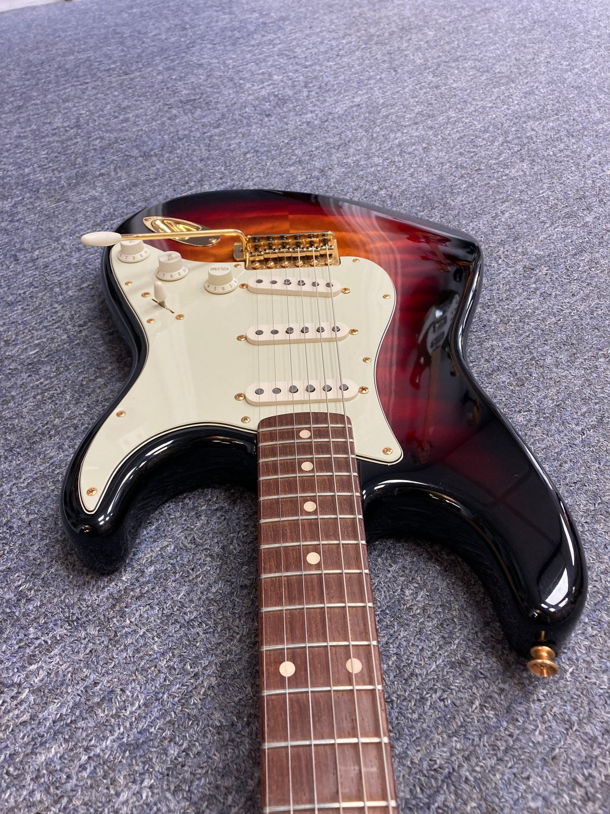 Fender Custom Shop 1960s FMT Stratocaster 1998, close-up of the guitar neck and body showcasing intricate craftsmanship and white volume knob.