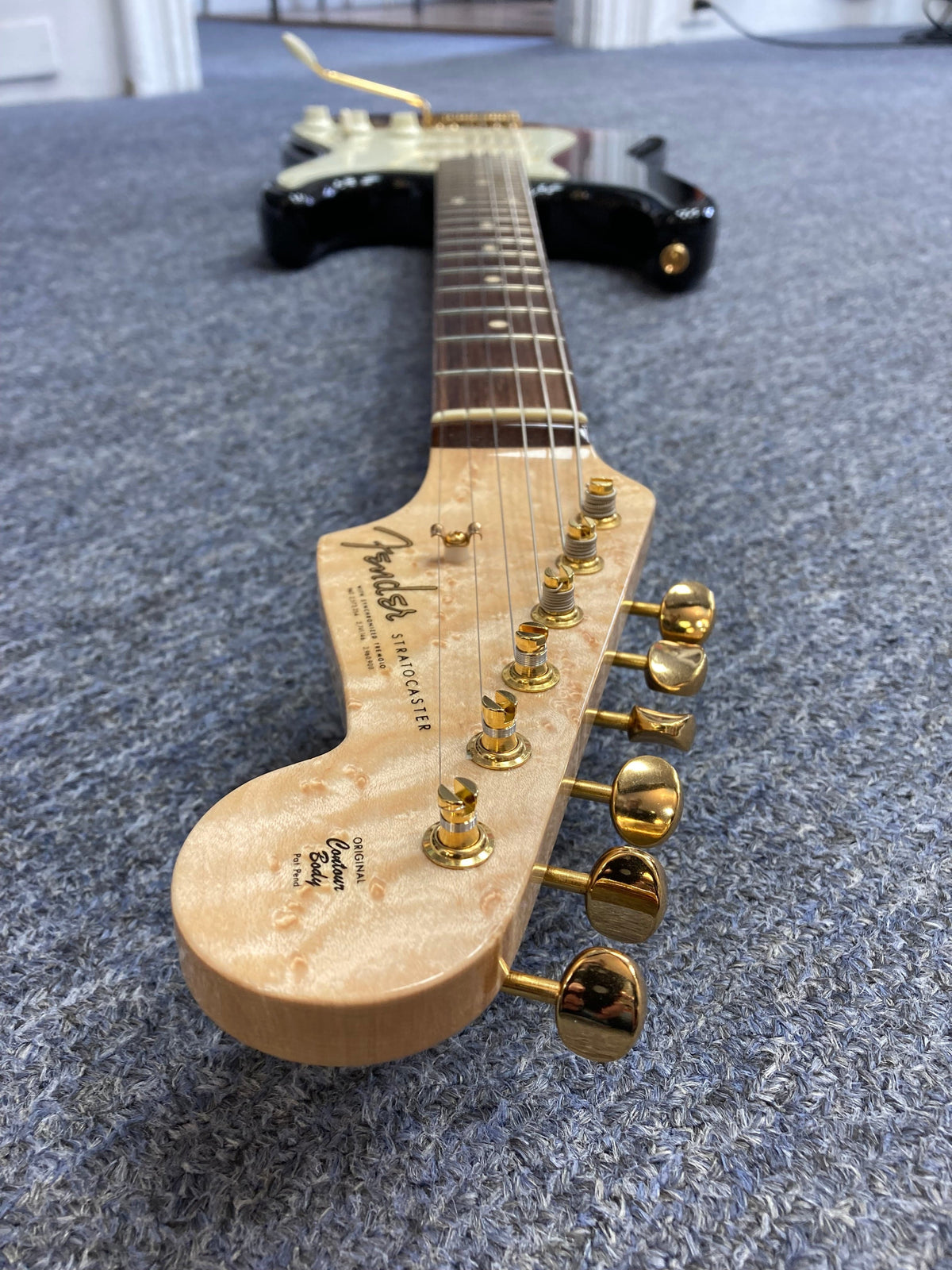 Close-up of a 1998 Fender Custom Shop 1960s FMJ Stratocaster, showcasing meticulous craftsmanship and iconic woodwork.