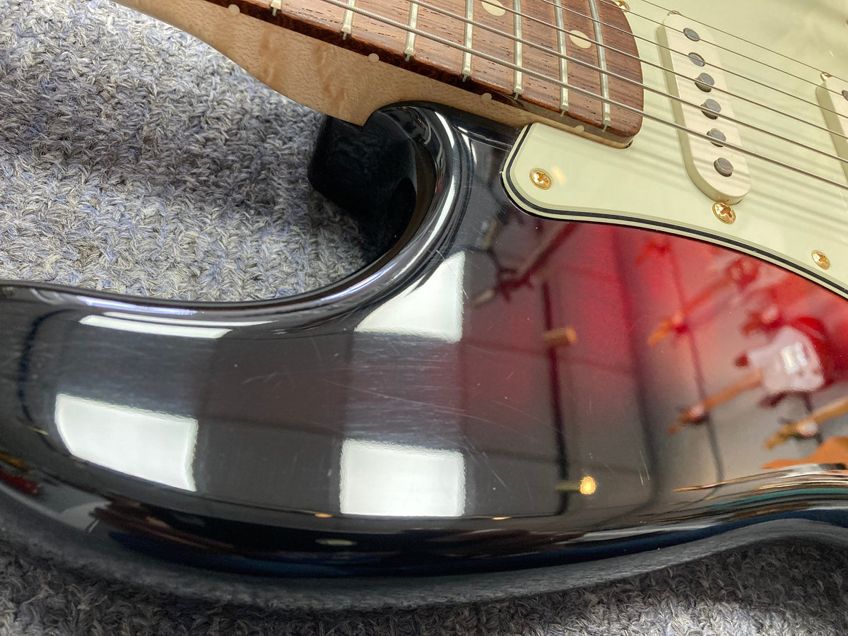 Close-up of a Fender Custom Shop 1960s FMJ Stratocaster 1998 guitar neck with strings, highlighting meticulous craftsmanship.