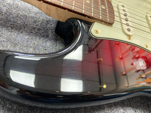 Close-up of a Fender Custom Shop 1960s FMJ Stratocaster 1998 guitar neck with strings, highlighting meticulous craftsmanship.