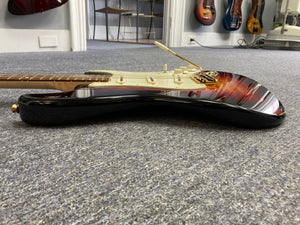 Fender Custom Shop 1960s FMJ Stratocaster 1998 on floor, showcasing meticulous craftsmanship and original features, including case candy and certificate of authenticity.