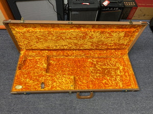 Open guitar case with 1998 Fender Custom Shop 1960s FMJ Stratocaster, original case candy, and certificate of authenticity.