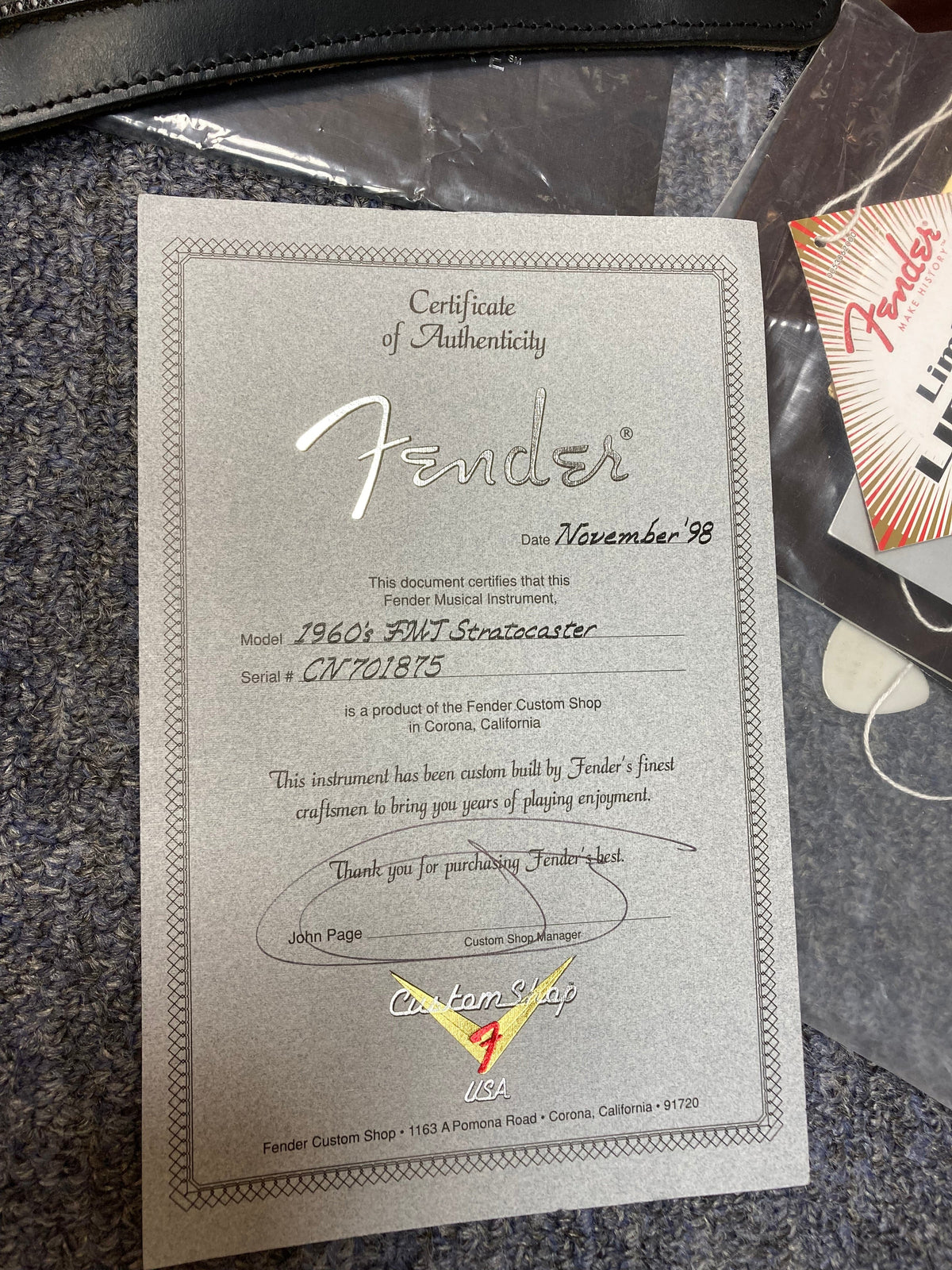 Certificate of authenticity for the 1998 Fender Custom Shop 1960s FMJ Stratocaster, featuring original case candy from Guitars on Main.