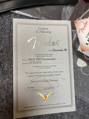 Certificate of authenticity for the 1998 Fender Custom Shop 1960s FMJ Stratocaster, featuring original case candy from Guitars on Main.