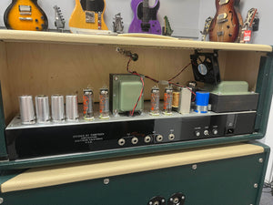 Guitar amplifier with visible components in a music store setting