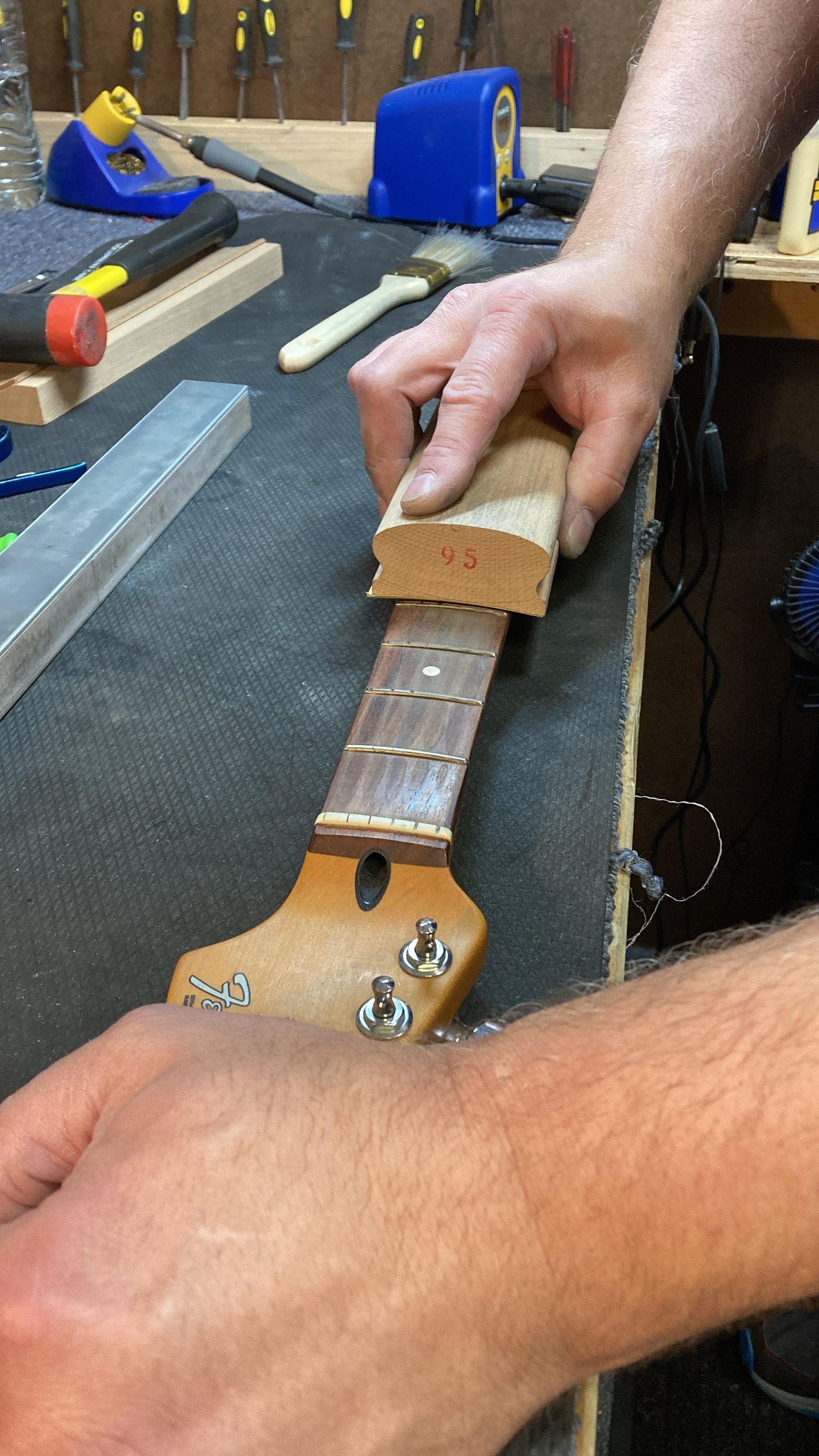 Guitar neck getting frets leveled. Guitar neck getting frets leveled.