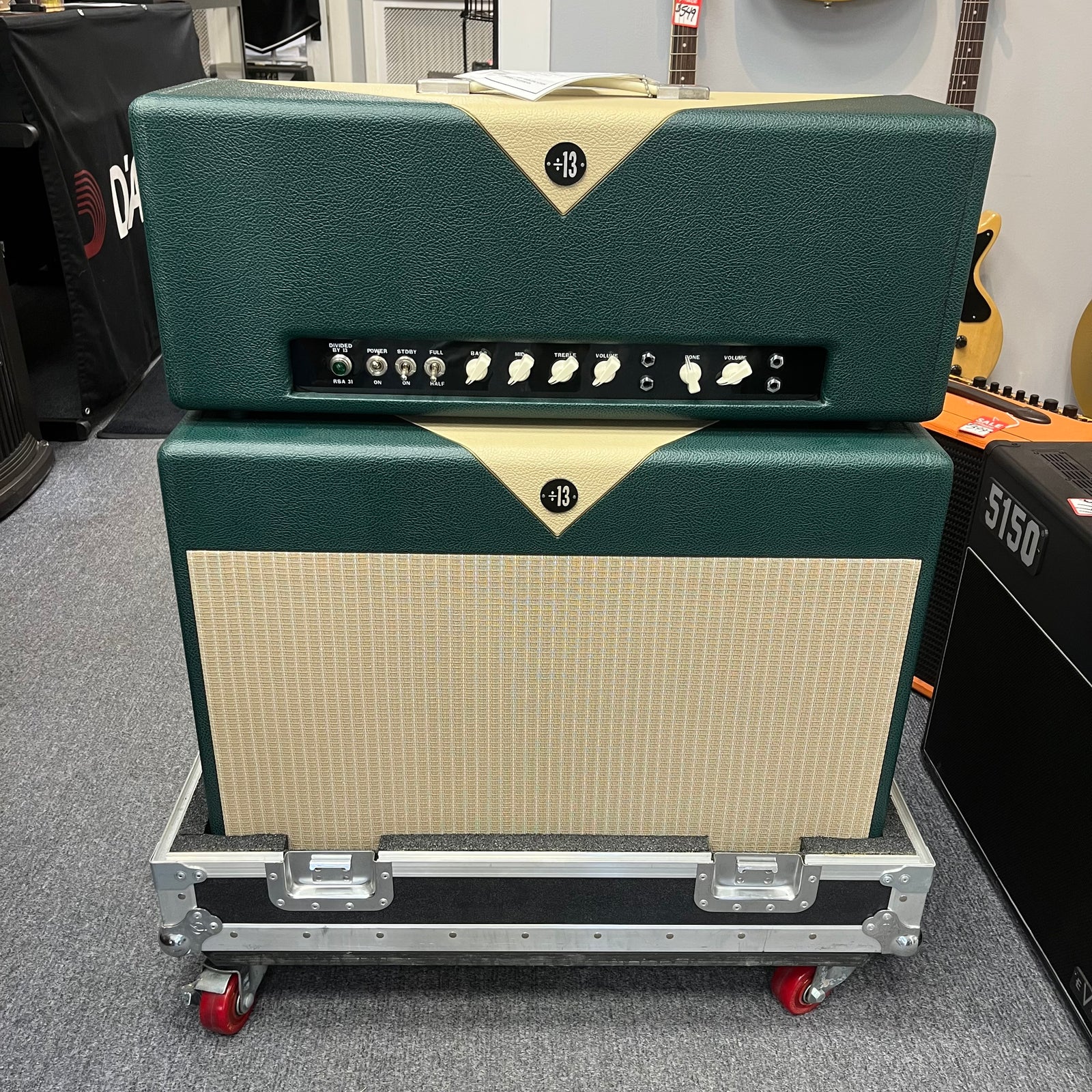 A 2005 Divided by 13 RSA 31 Head with matching 2x12 cabinet and flight case is displayed in a music store, featuring the distinctive boutique design from Divided by 13. Local pickup only. A 2005 Divided by 13 RSA 31 Head with matching 2x12 cabinet and flight case is displayed in a music store, featuring the distinctive boutique design from Divided by 13. Local pickup only.