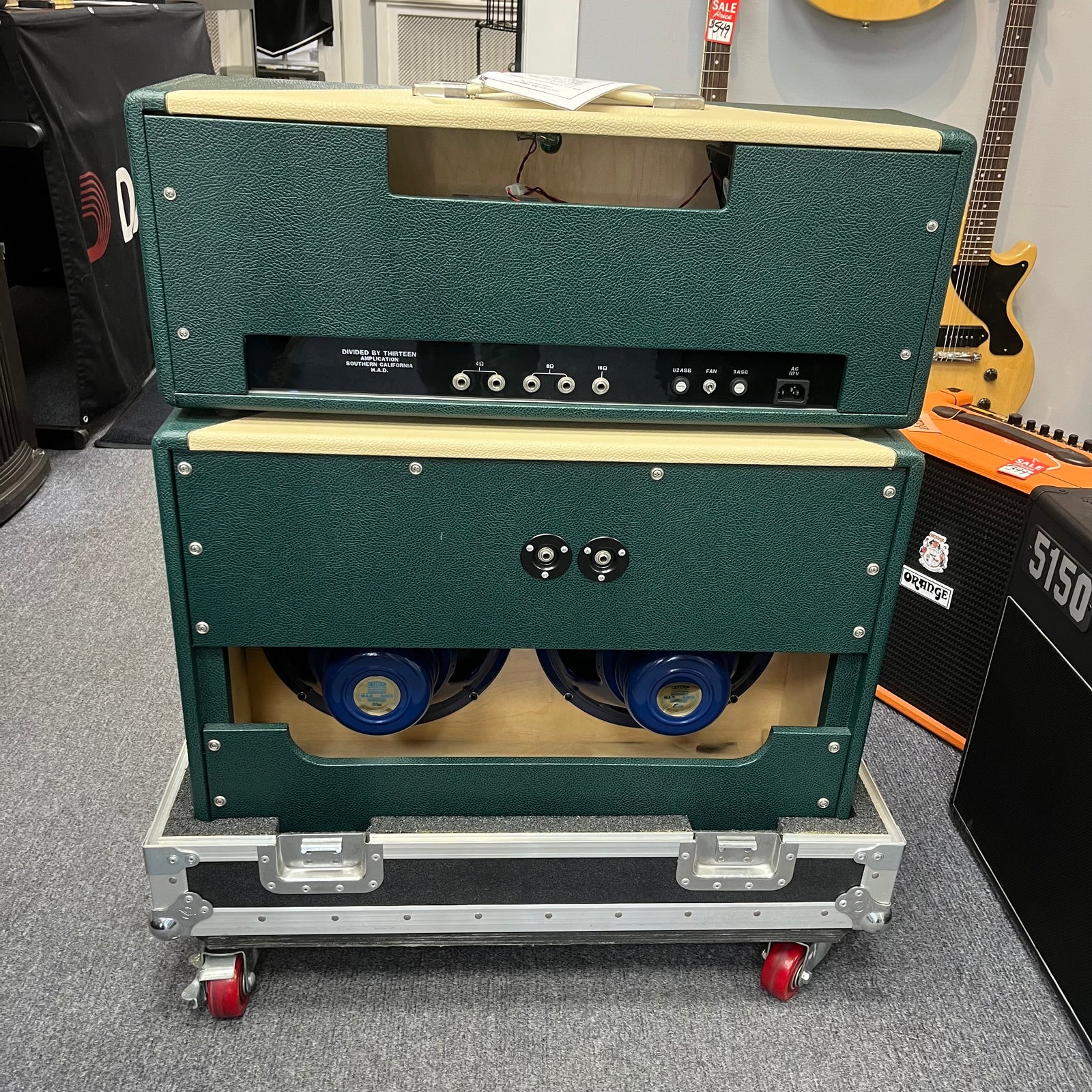 A 2005 Divided by 13 RSA 31 Head with matching 2x12 cabinet and flight case is displayed in a music store, featuring the distinctive boutique design from Divided by 13. Local pickup only. A 2005 Divided by 13 RSA 31 Head with matching 2x12 cabinet and flight case is displayed in a music store, featuring the distinctive boutique design from Divided by 13. Local pickup only.