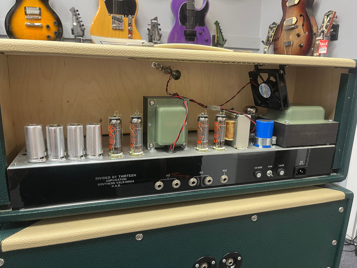 Guitar amplifier with visible components in a music store setting