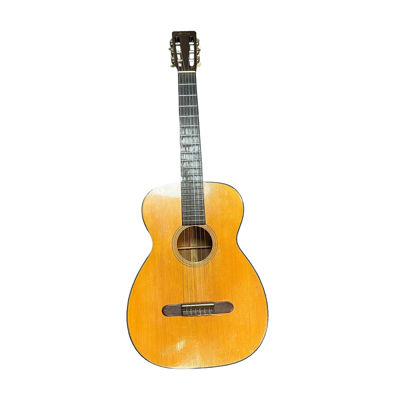 The Martin 00-18G Classical Guitar (c. 1961–1962) features a natural wood finish, six nylon strings, visible body wear, and a round sound hole—showcasing Martin’s timeless vintage charm.