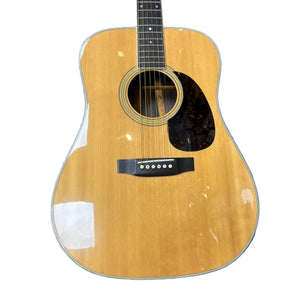 The Sigma Vintage DR-35 Acoustic Guitar, made in Japan, features a natural wood finish, black pickguard, six strings, and comes with a case. The lower part of this dreadnought is shown against a white background.