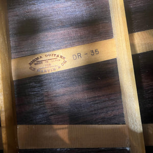 Close-up of a Vintage Sigma DR-35 Acoustic Guitar interior shows the "SIGMA GUITARS MADE IN JAPAN FOR C.F. MARTIN & CO. DR-35" stamp, wood braces, and grain, highlighting this Sigma model inspired by the Martin D-35. Includes case.